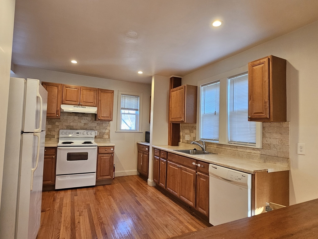 a kitchen with stainless steel appliances granite countertop a stove and a sink