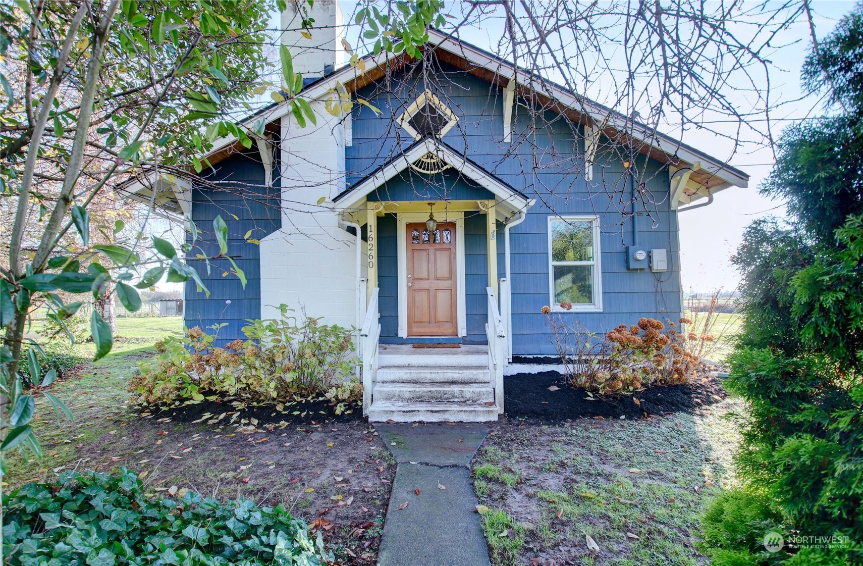 a front view of a house with garden