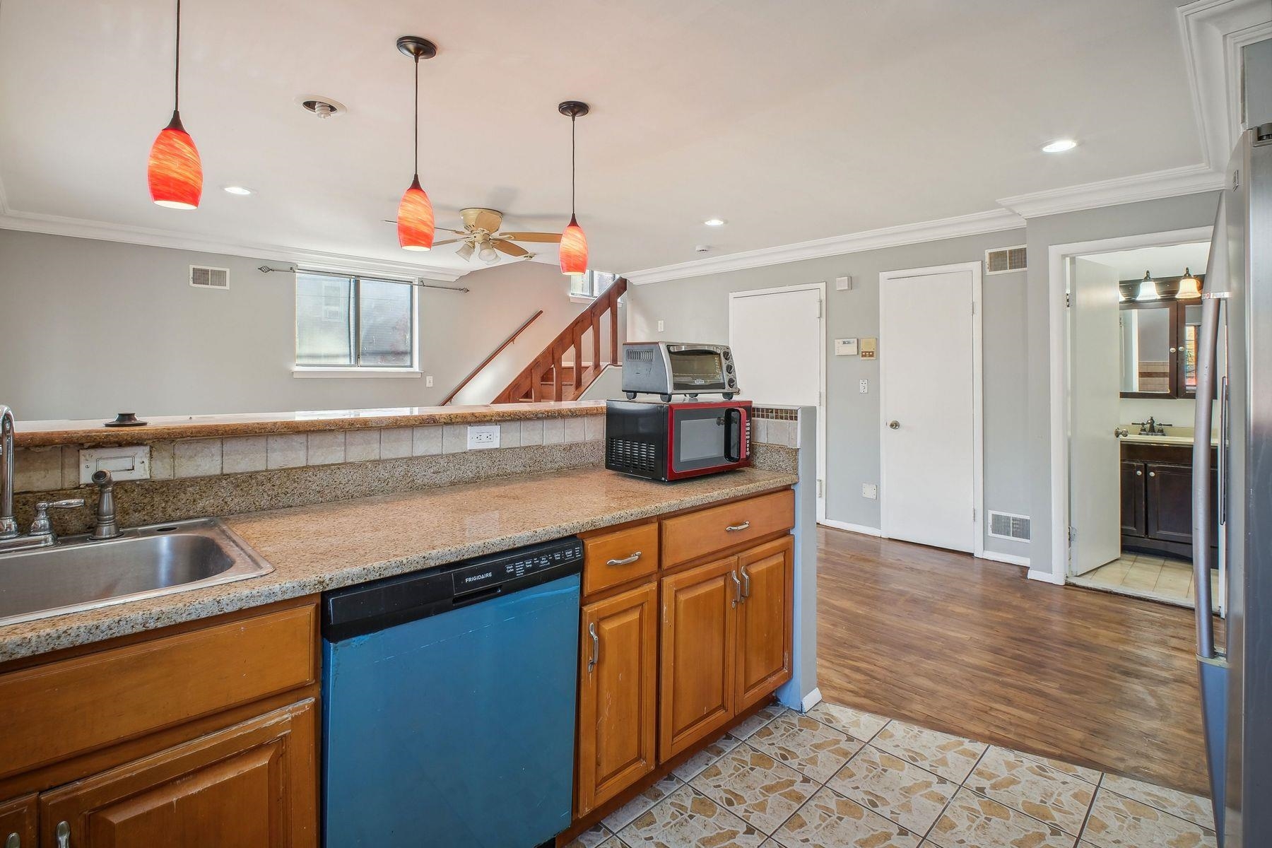 a kitchen with stainless steel appliances granite countertop a sink and a refrigerator