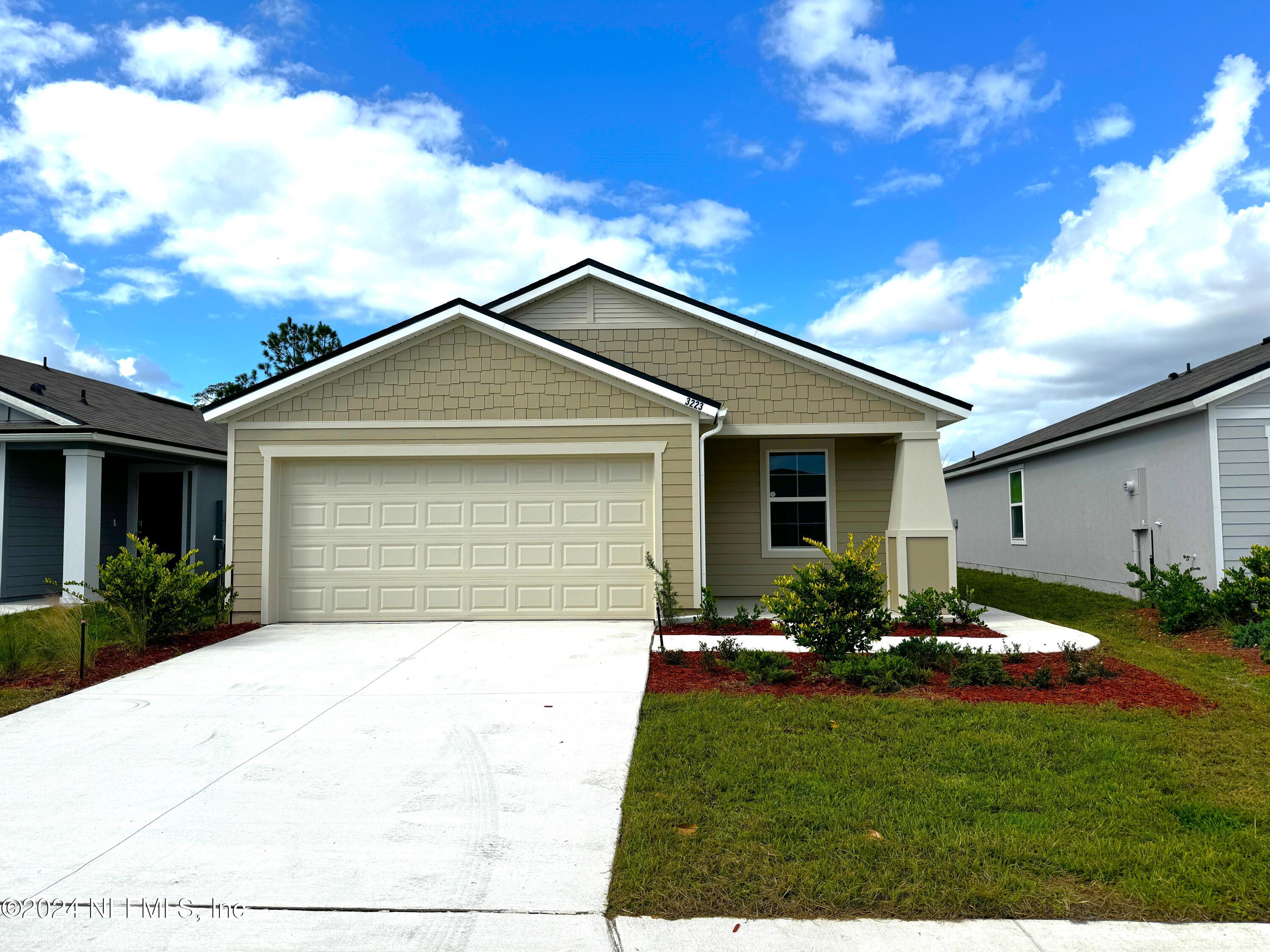 a front view of house with yard and green space