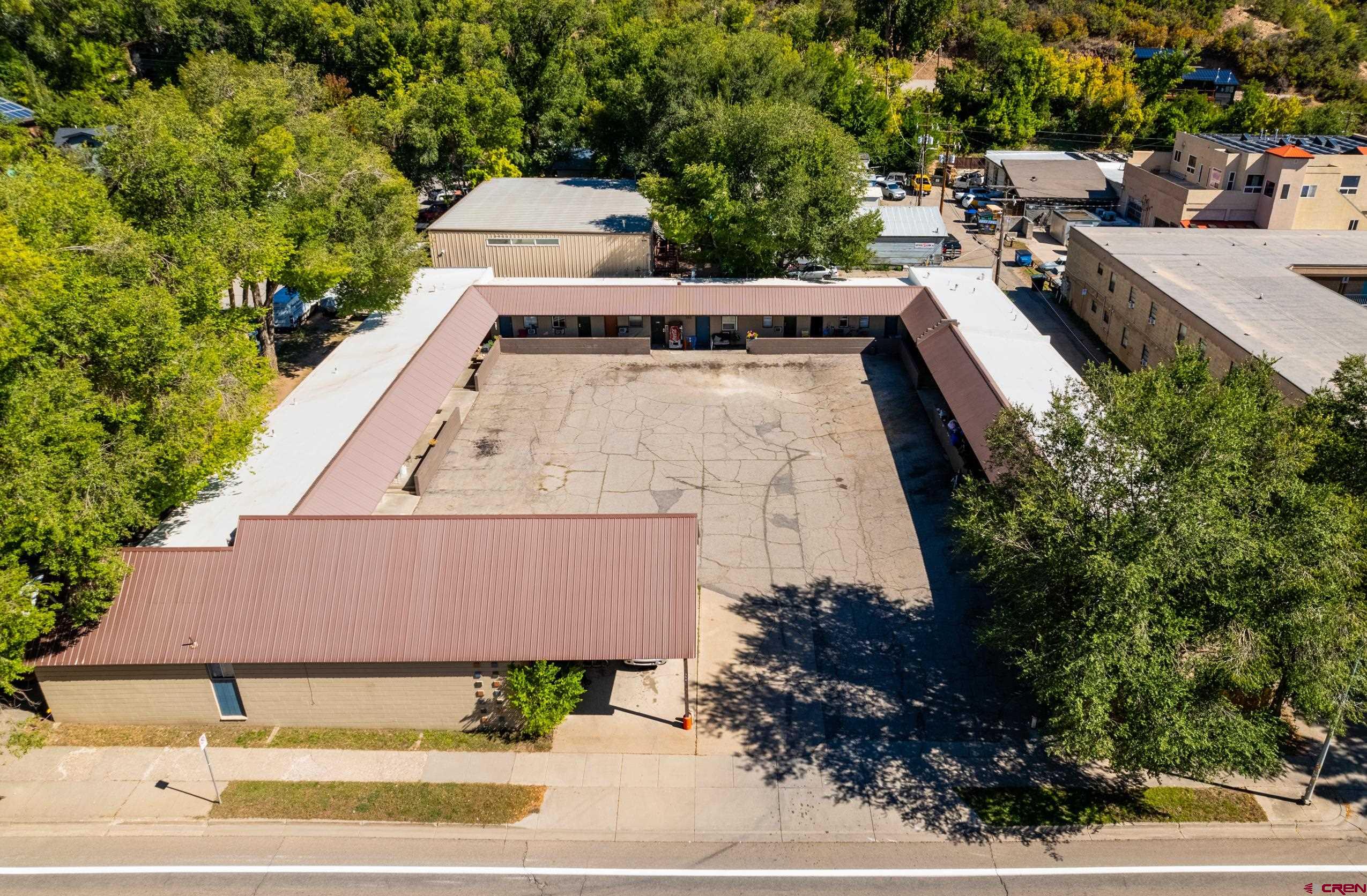 an aerial view of a house with a yard and lake view