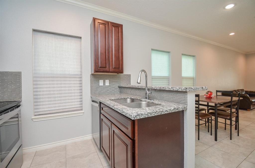 a kitchen with a sink stove and cabinets