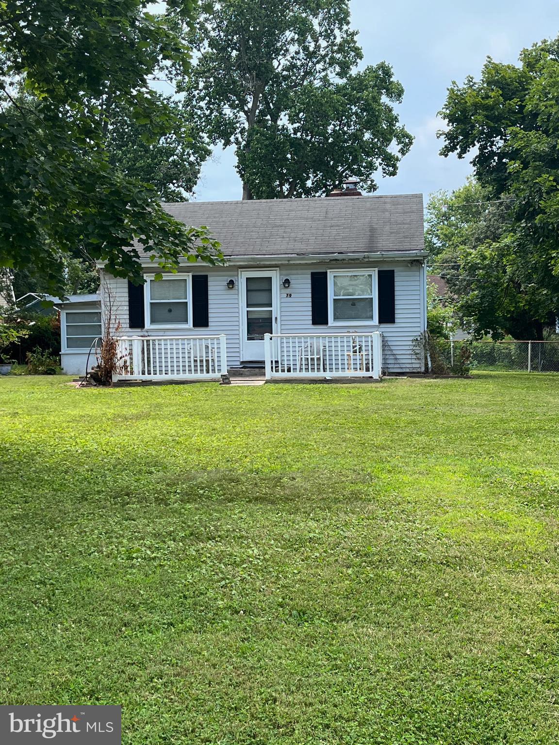 a front view of house with yard and trees