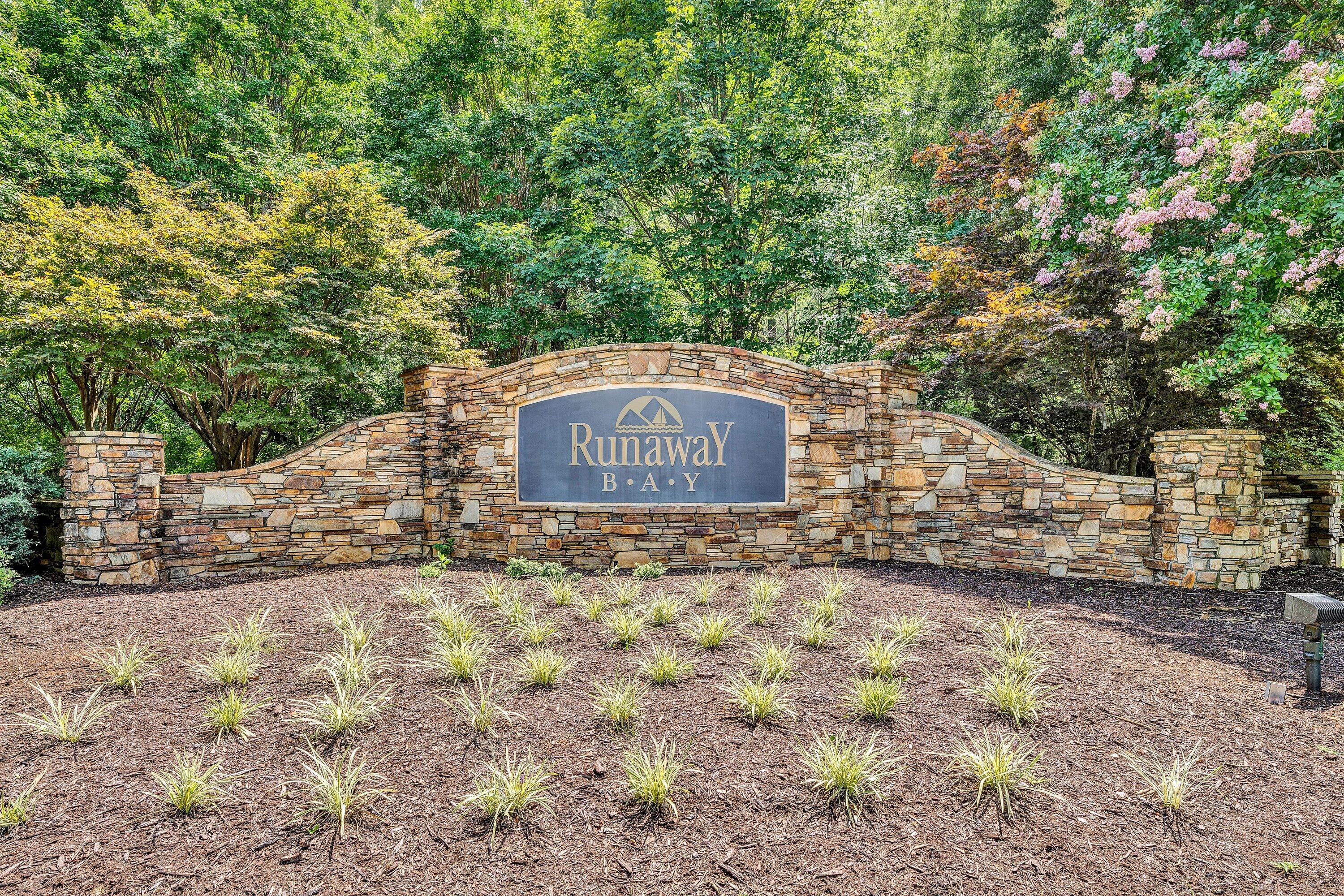 a sign board with tall trees