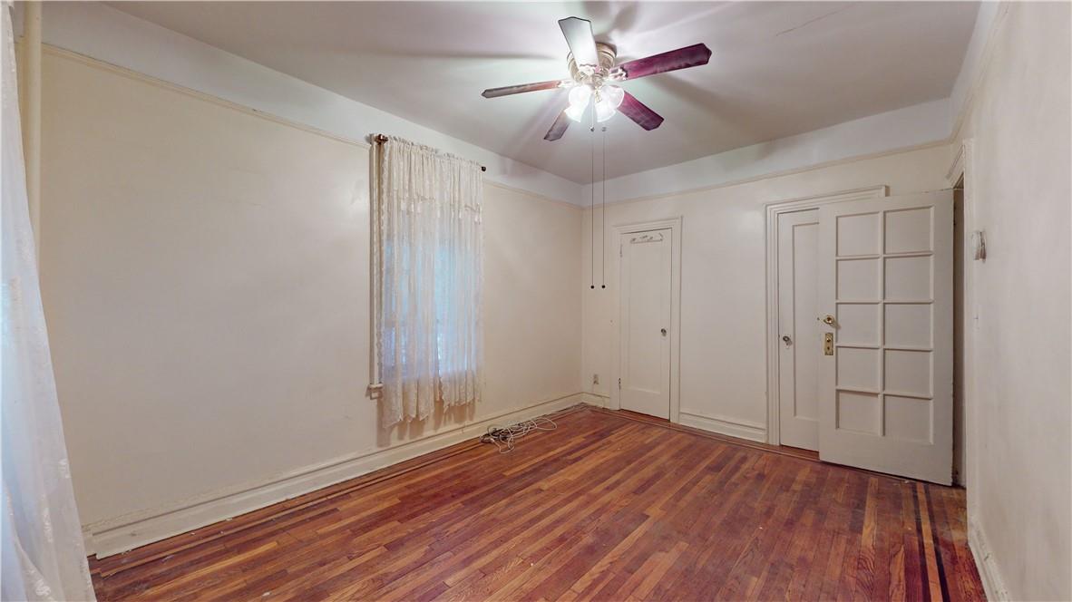 Unfurnished bedroom with wood-type flooring, a closet, and ceiling fan