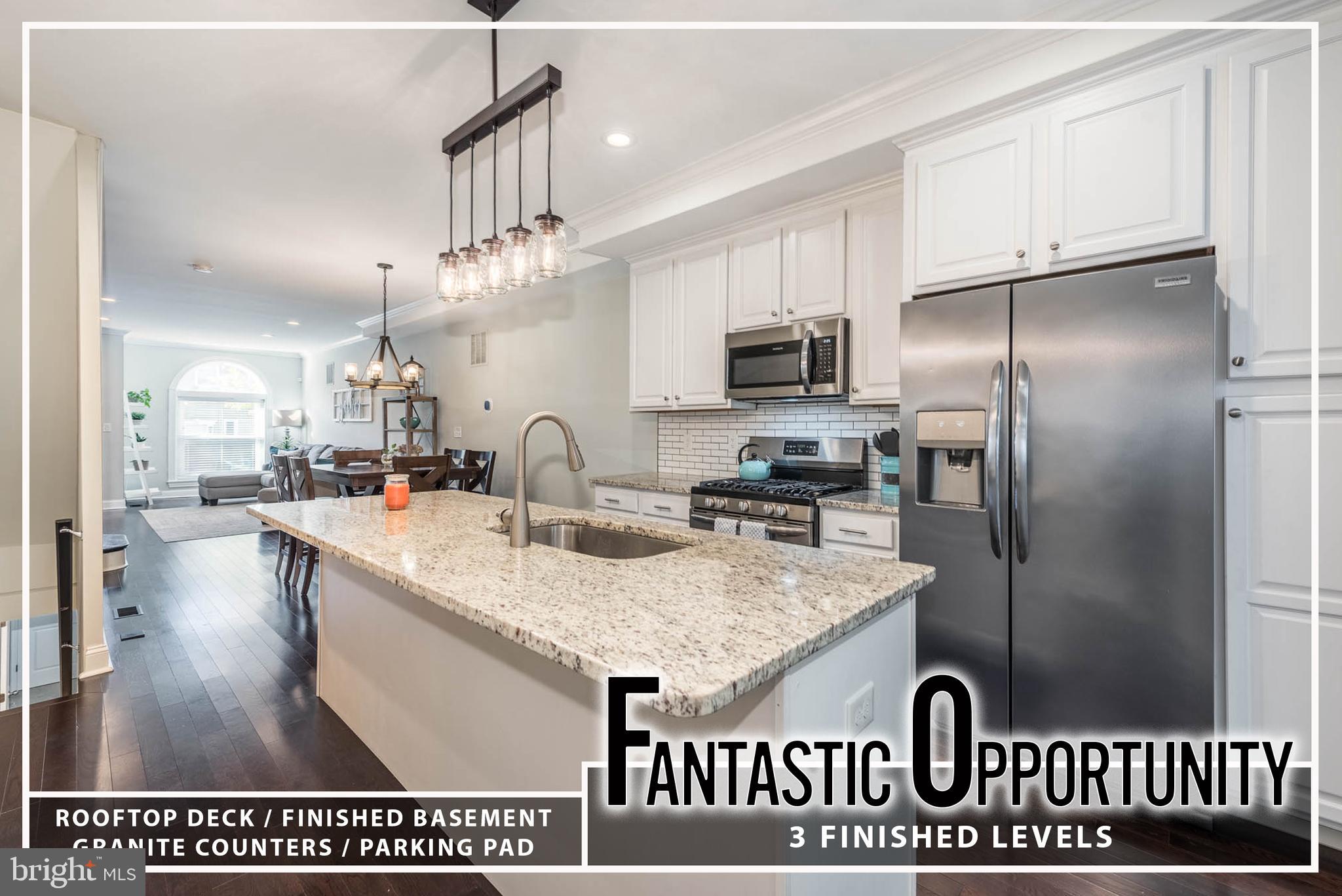 a kitchen with kitchen island granite countertop a sink stainless steel appliances and counter space