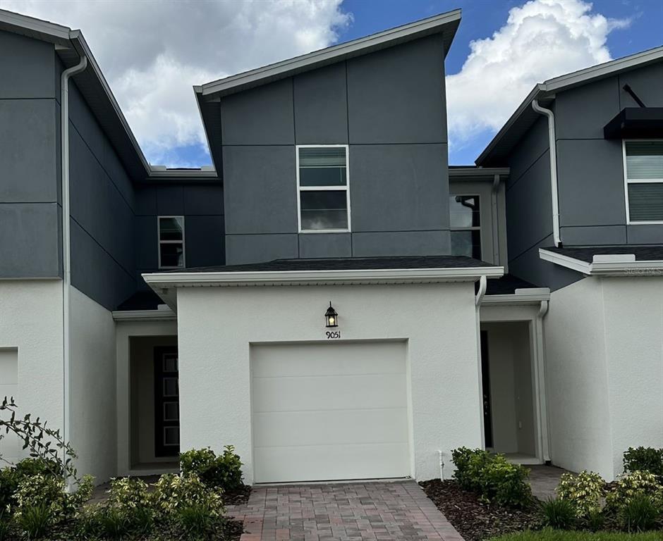 a front view of a house with garage