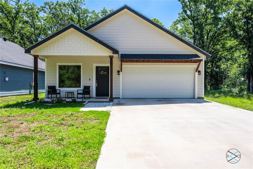 a front view of house with yard and outdoor seating