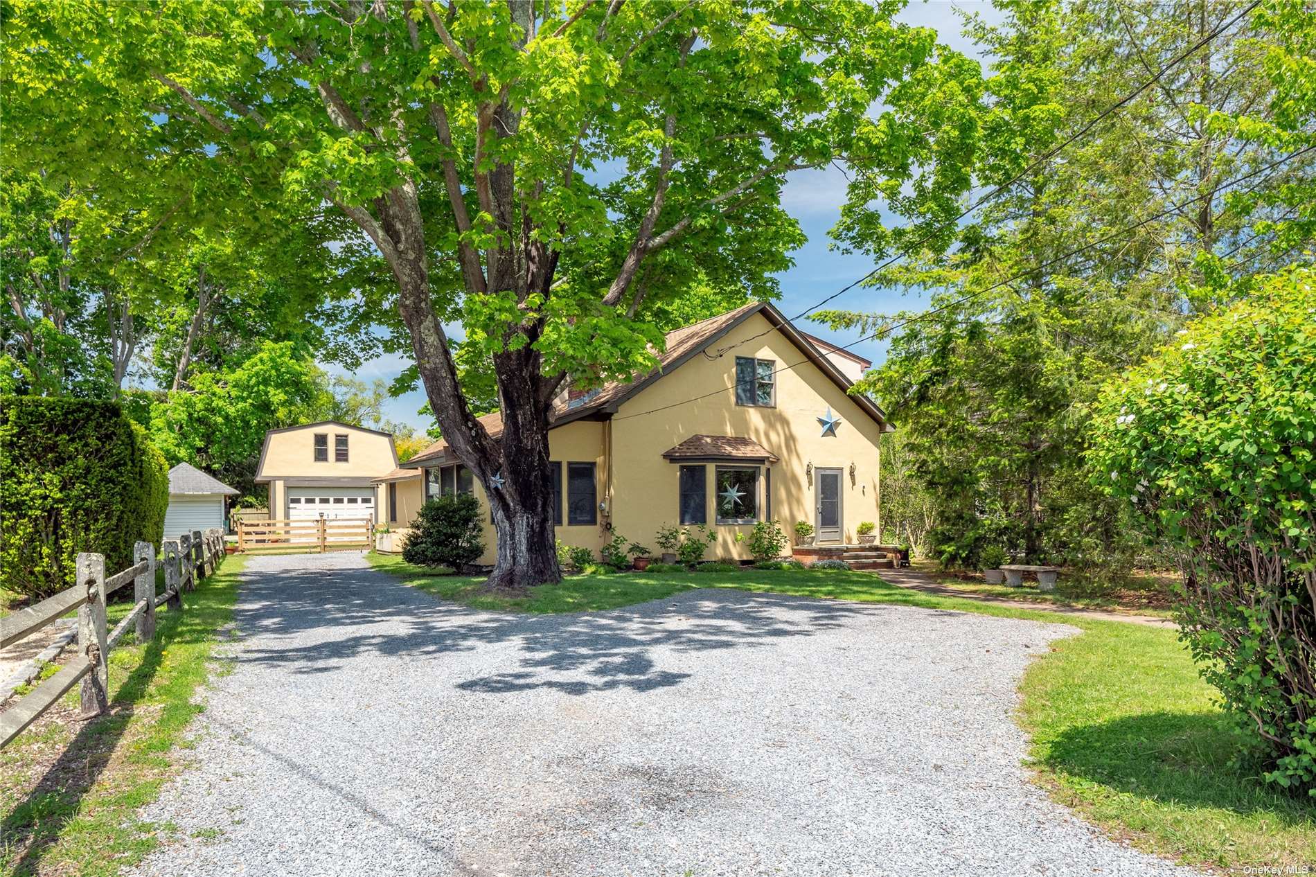 a front view of a house with a yard and trees