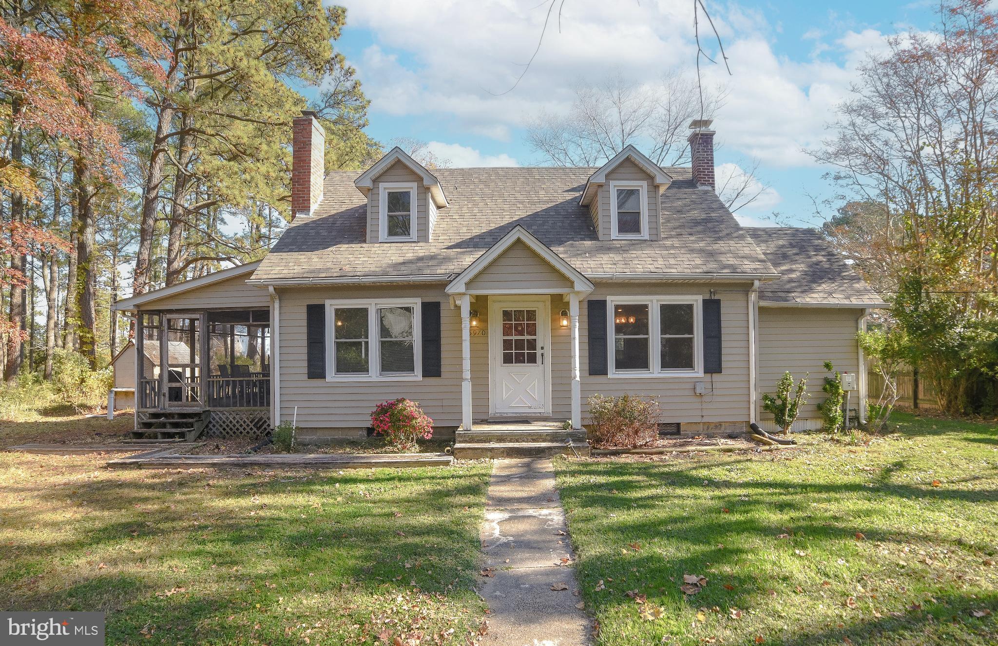 a front view of house with yard outdoor seating and barbeque oven