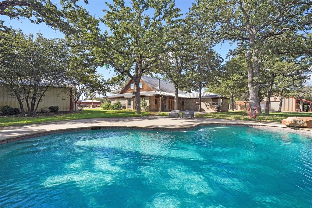 a view of a house with swimming pool and a yard