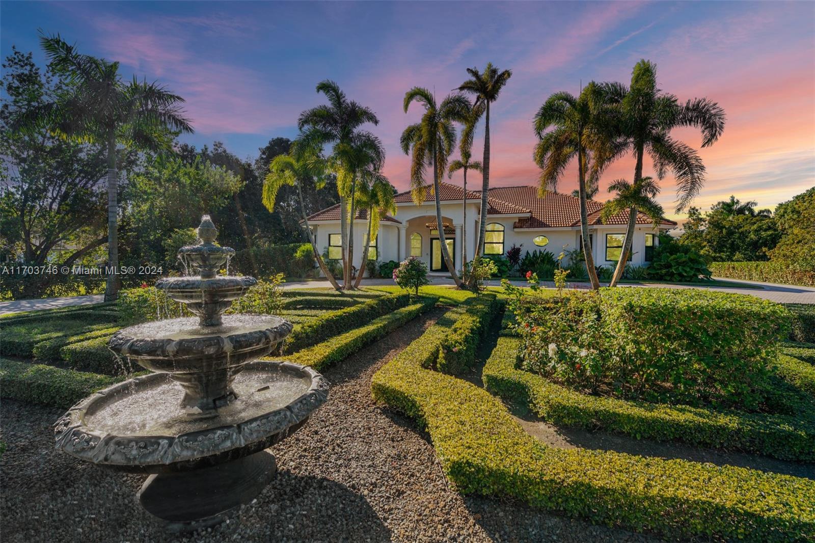 a view of a fountain in front of a house