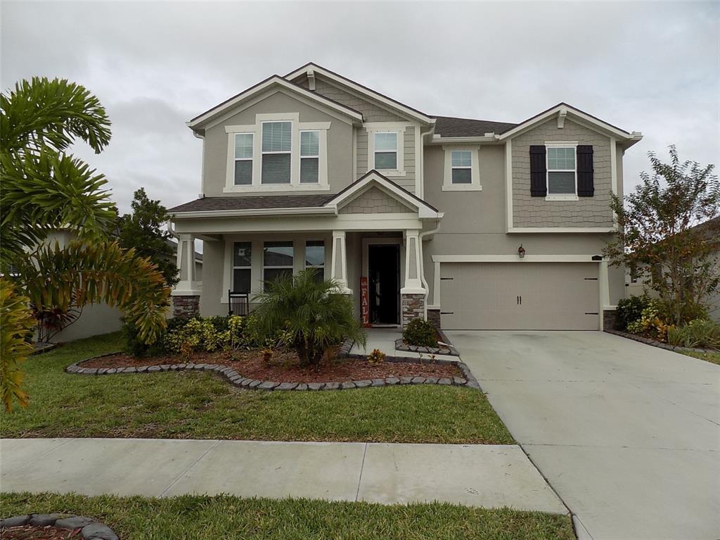 a front view of a house with a yard and garage