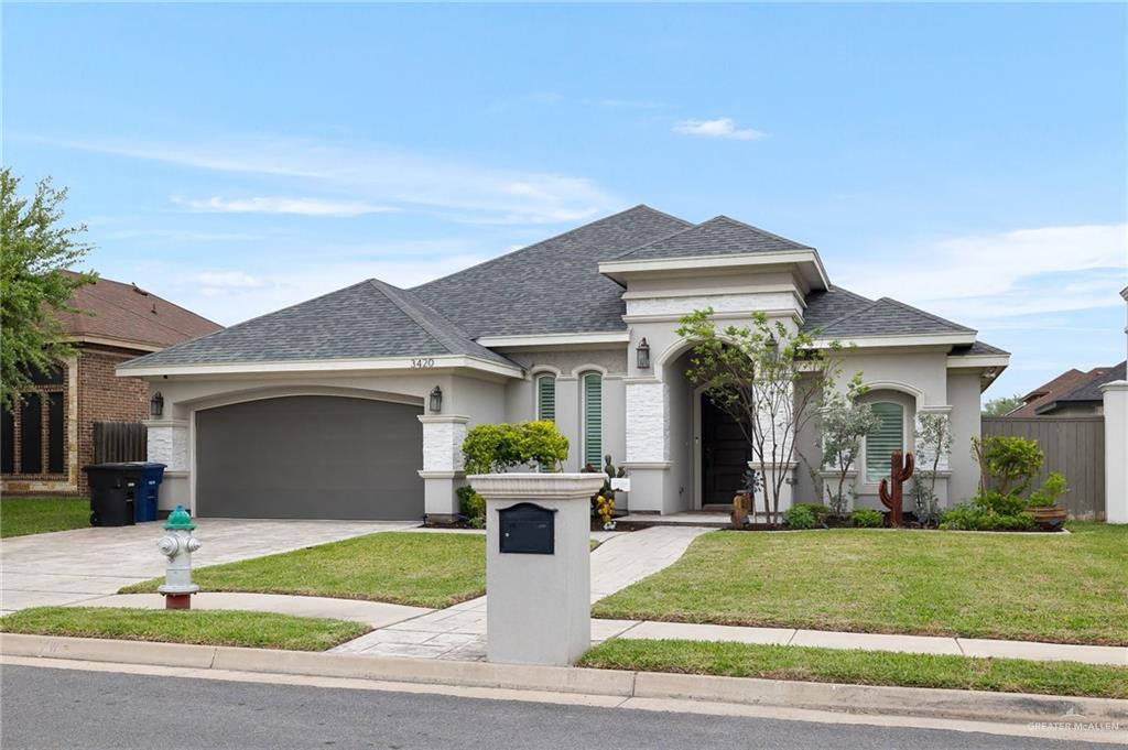 a front view of a house with a yard and garage