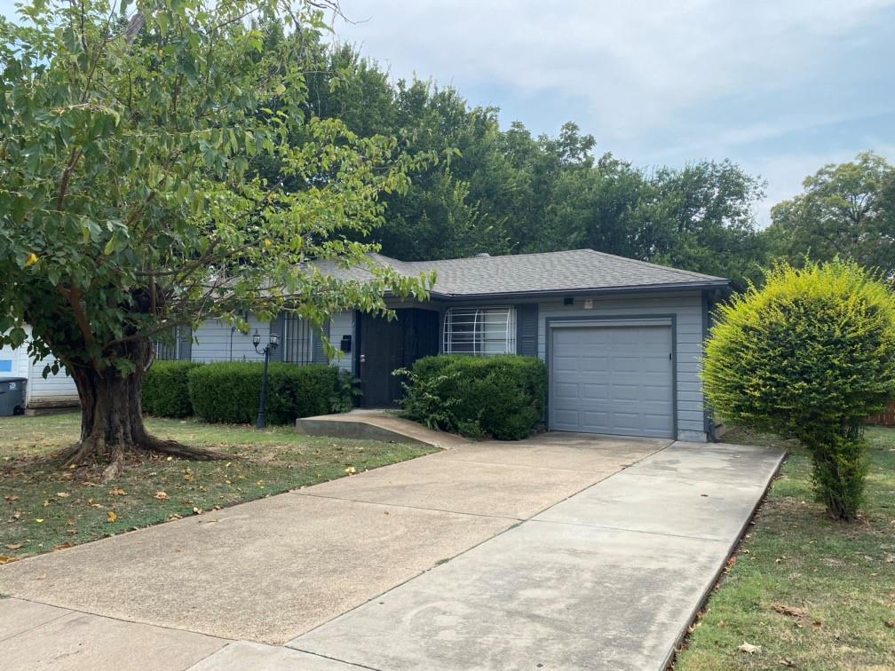 a front view of a house with a yard and trees