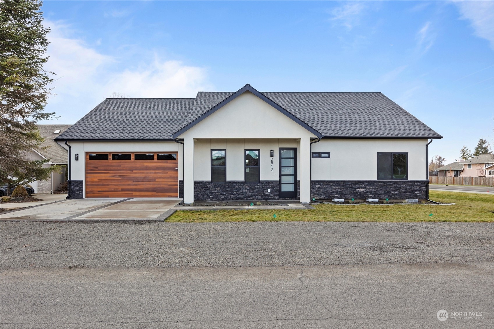 a front view of a house with a yard and swimming pool