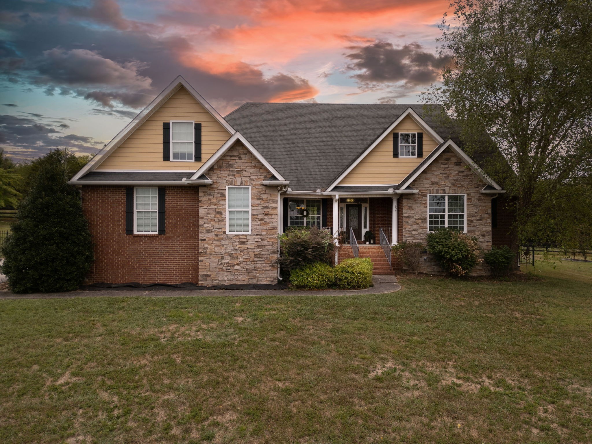 a front view of a house with a garden