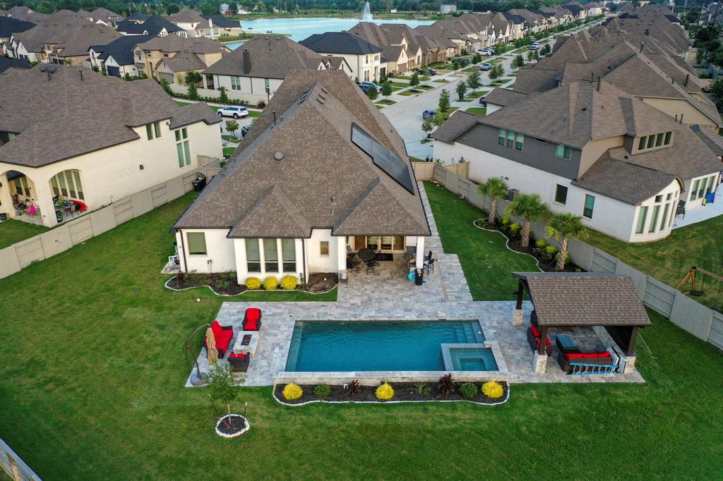 an aerial view of multiple houses with yard