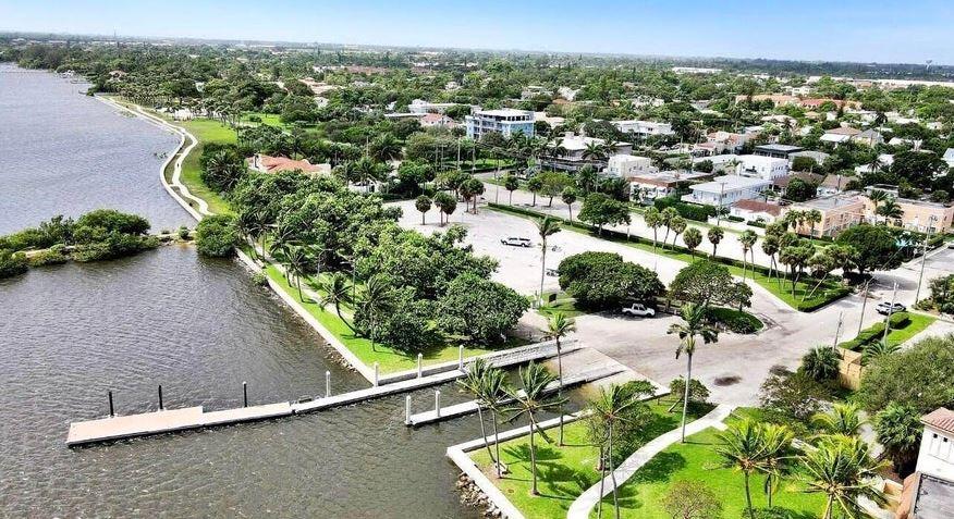 an aerial view of a house with a yard and lake view