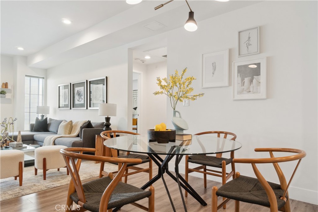 a dining room with furniture and wooden floor