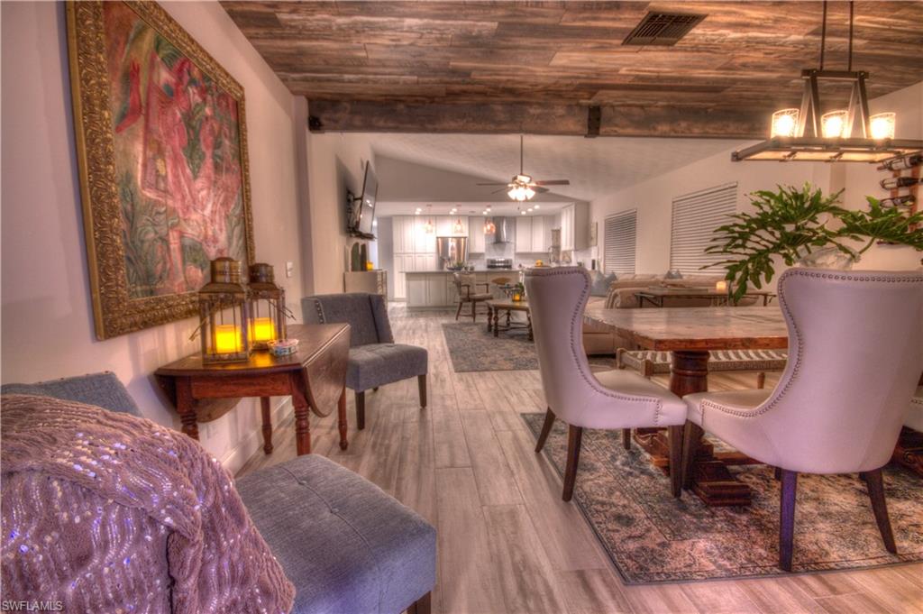 a view of a dining room with furniture and chandelier