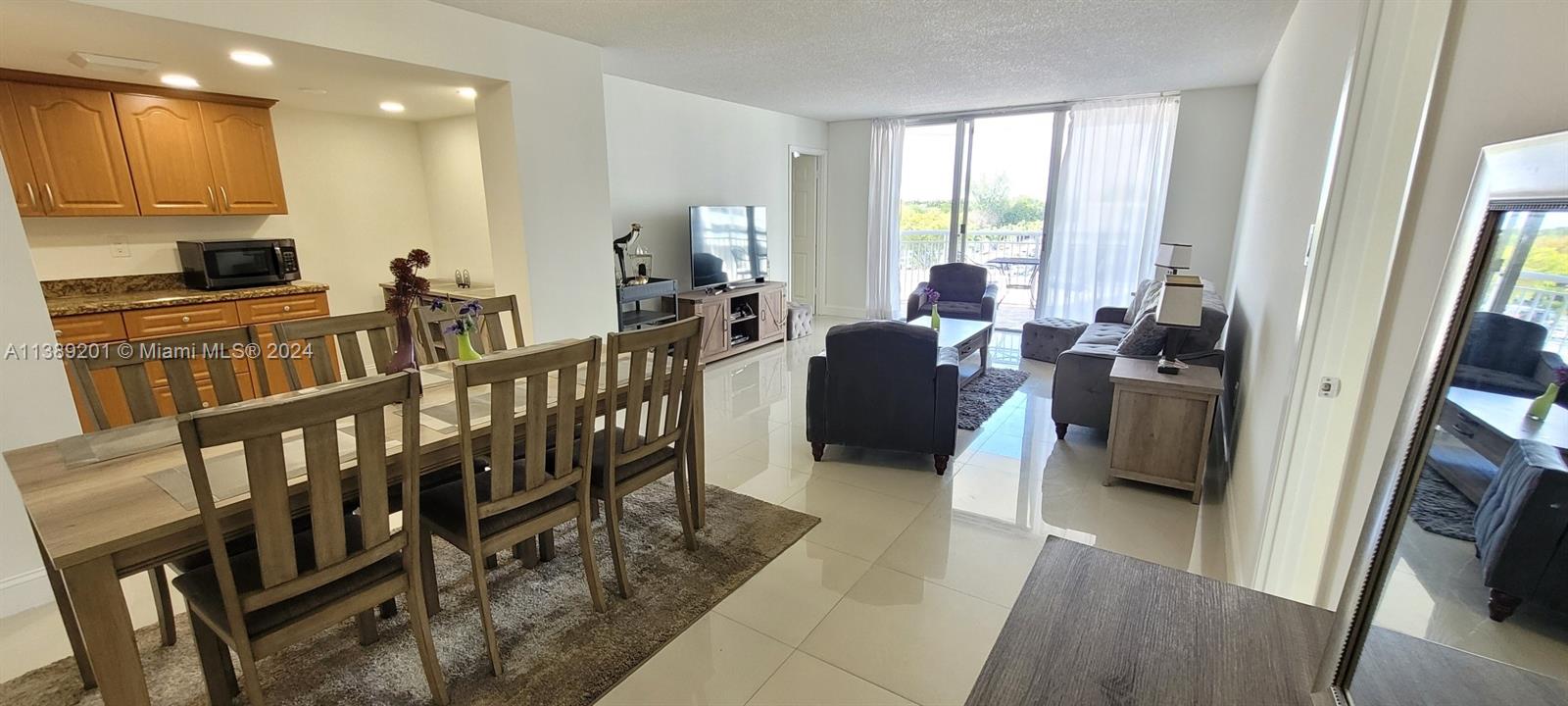 a view of living room with furniture and a flat screen tv