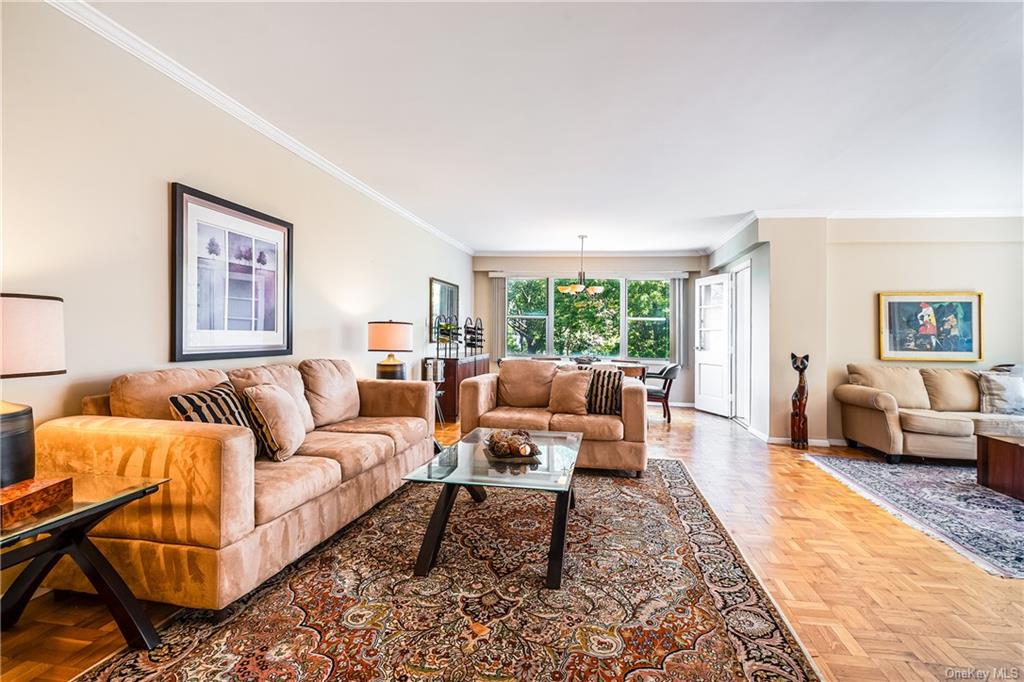 a living room with furniture wooden floor and a large window