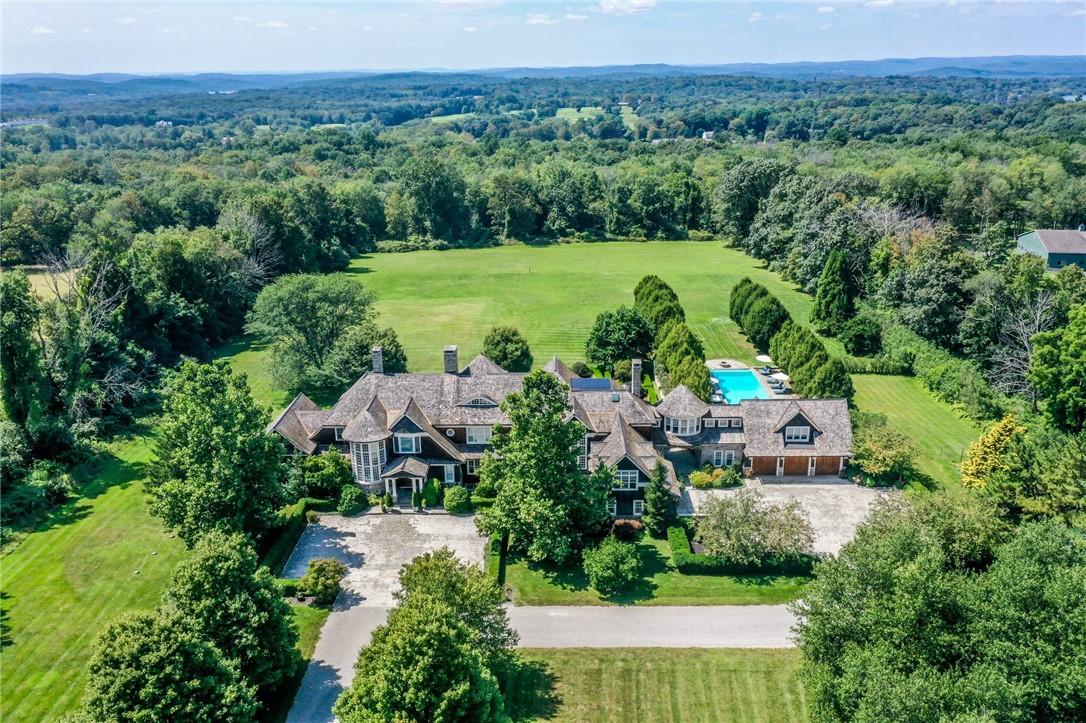 an aerial view of a house with a yard