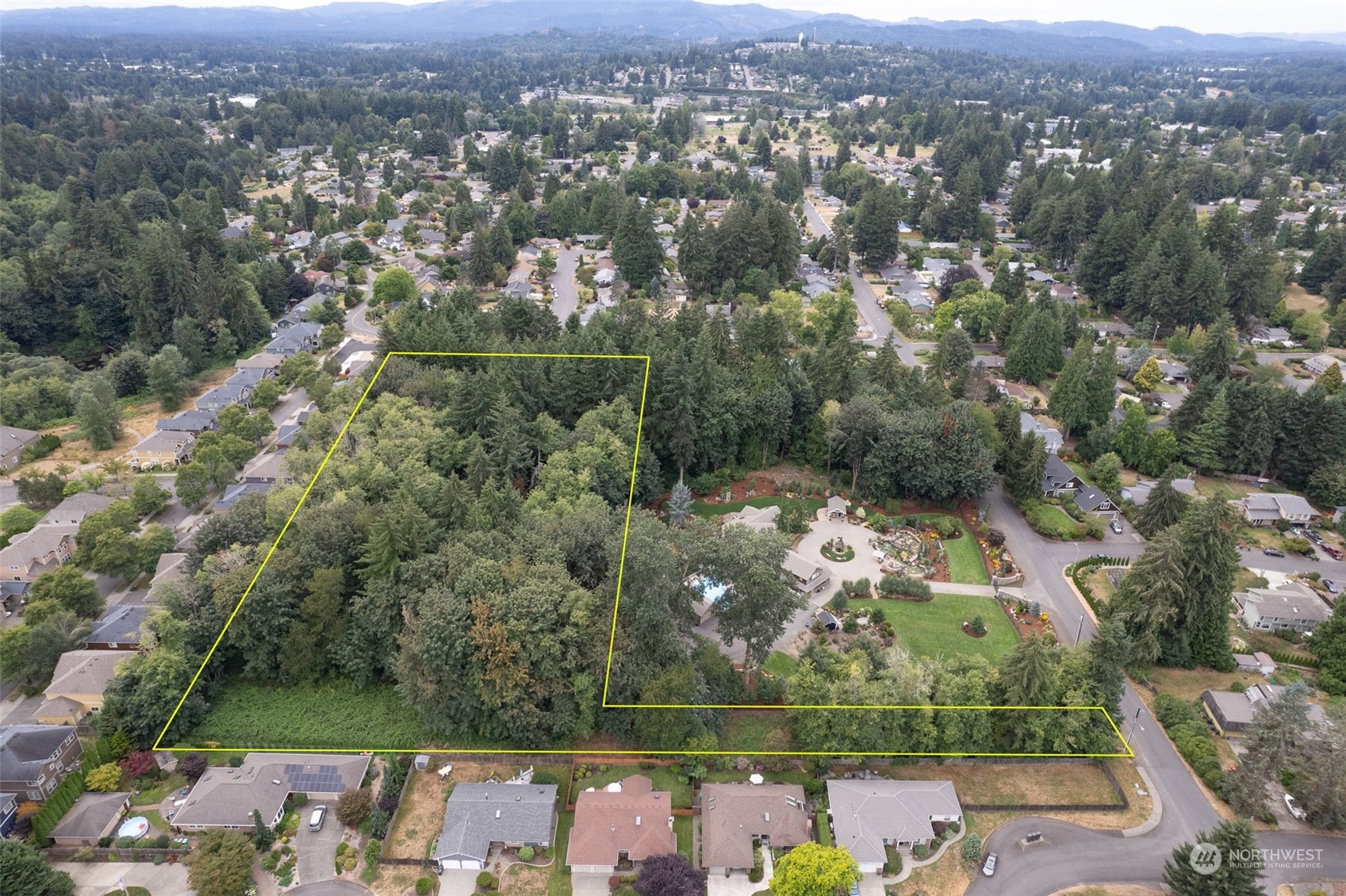 an aerial view of a houses with a yard