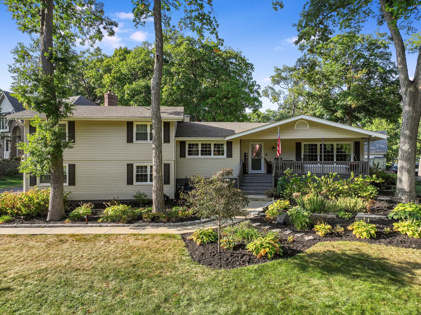 a front view of house with yard and trees around