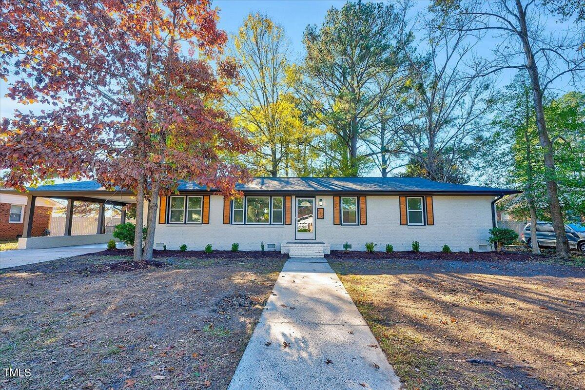 a house that has a tree in front of it