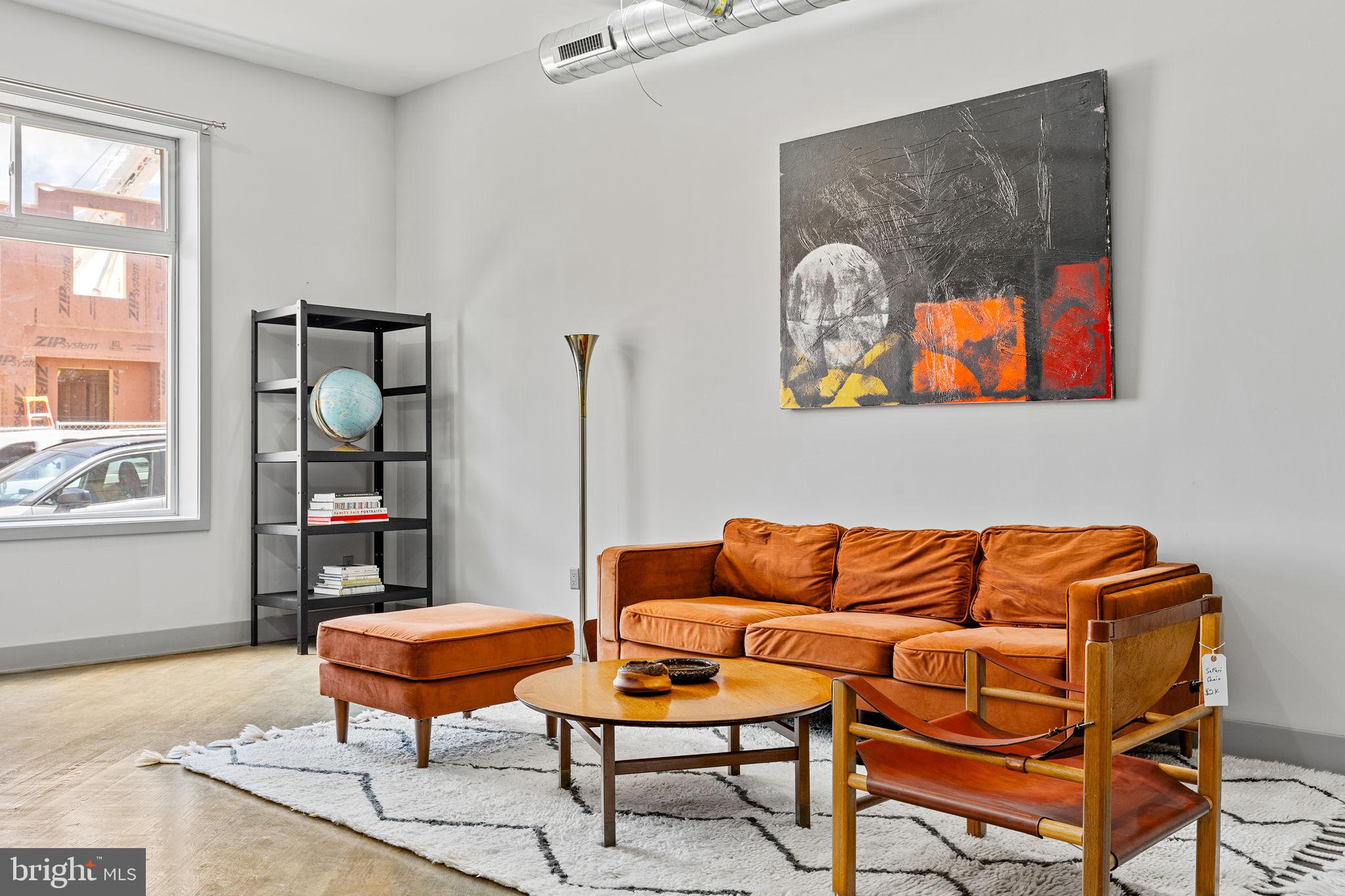 a blue couch sitting in a living room next to a window