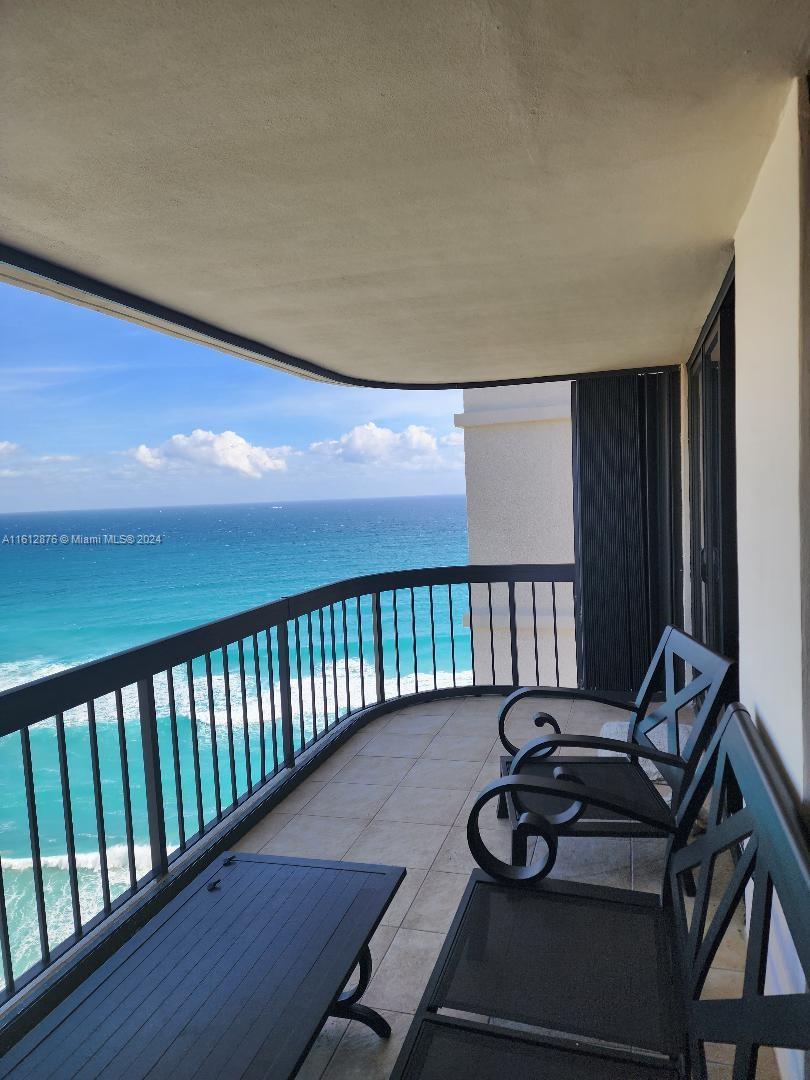 a view of a balcony with chairs