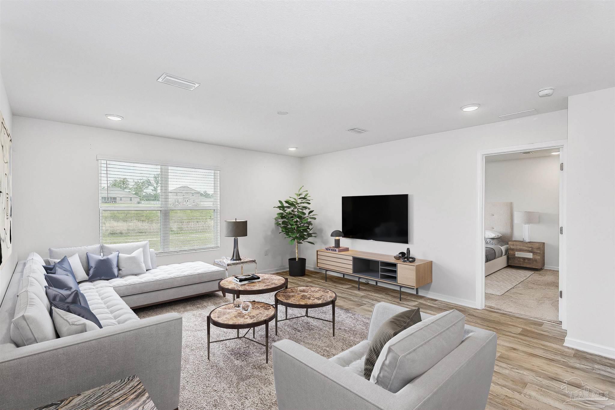 a living room with furniture and a flat screen tv