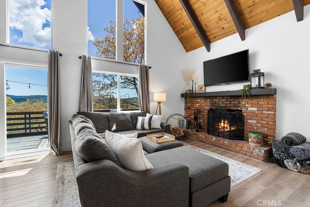 a living room with furniture fireplace and flat screen tv