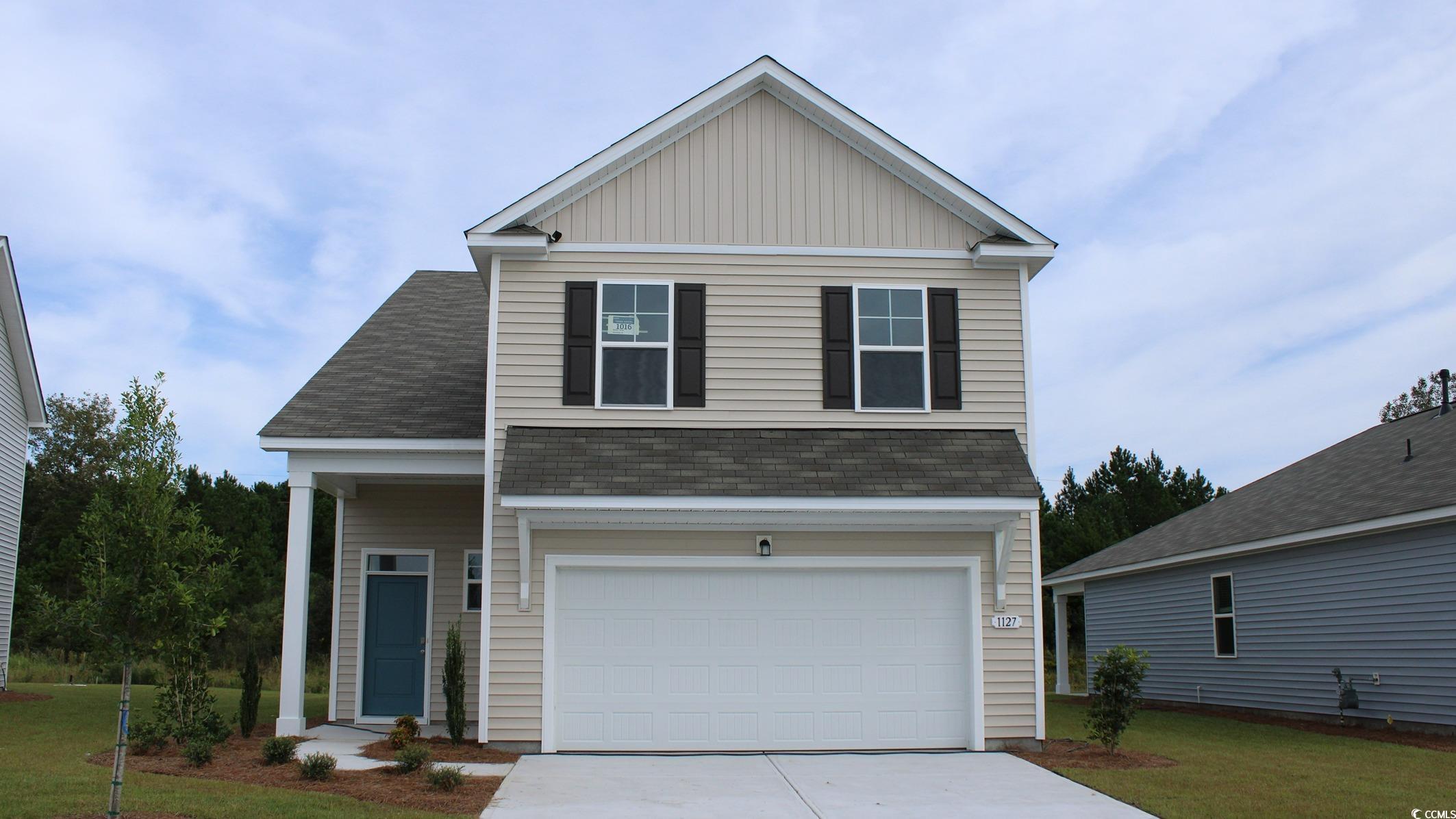 View of front of property featuring a garage and a