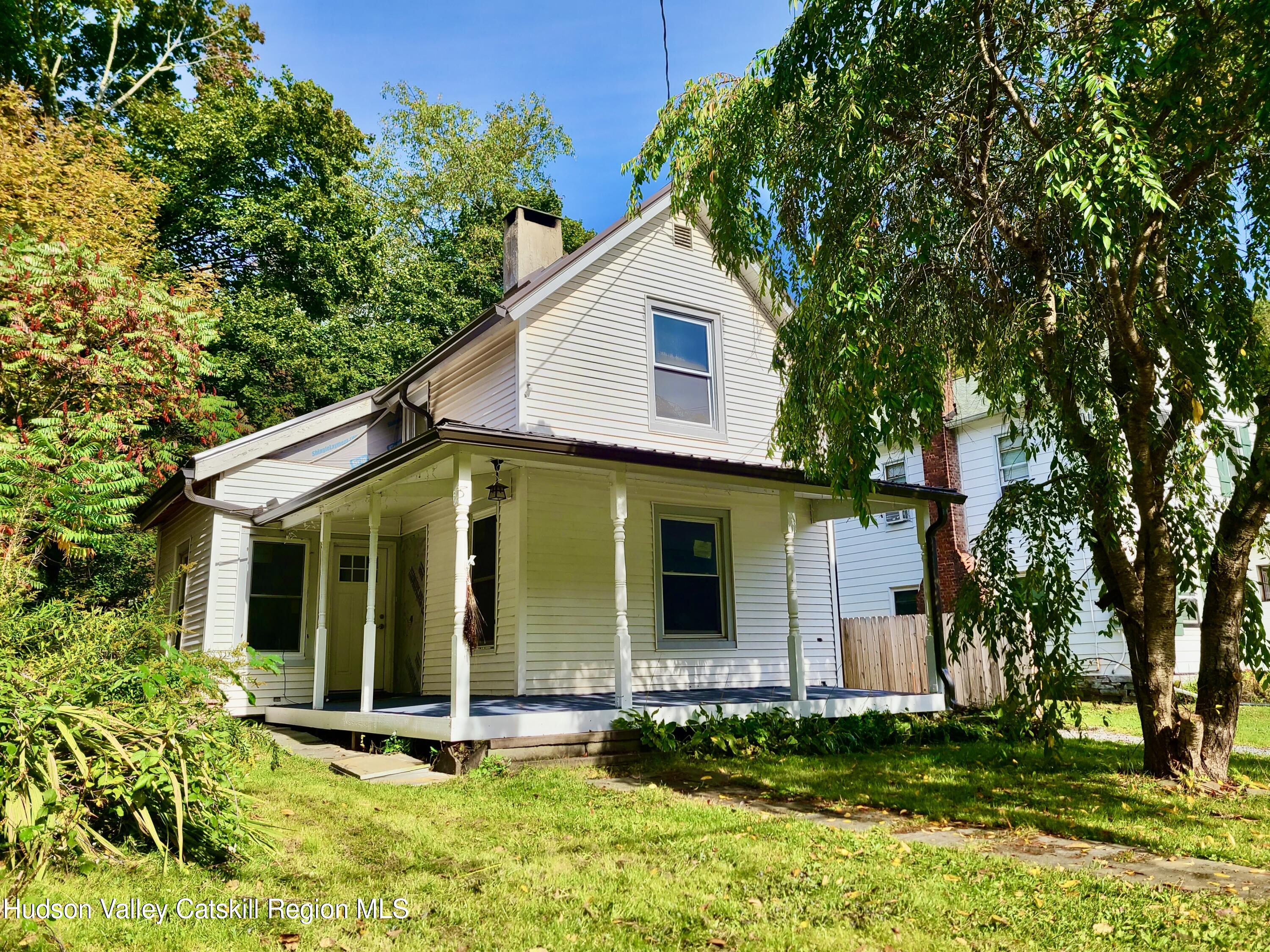 a view of house with yard