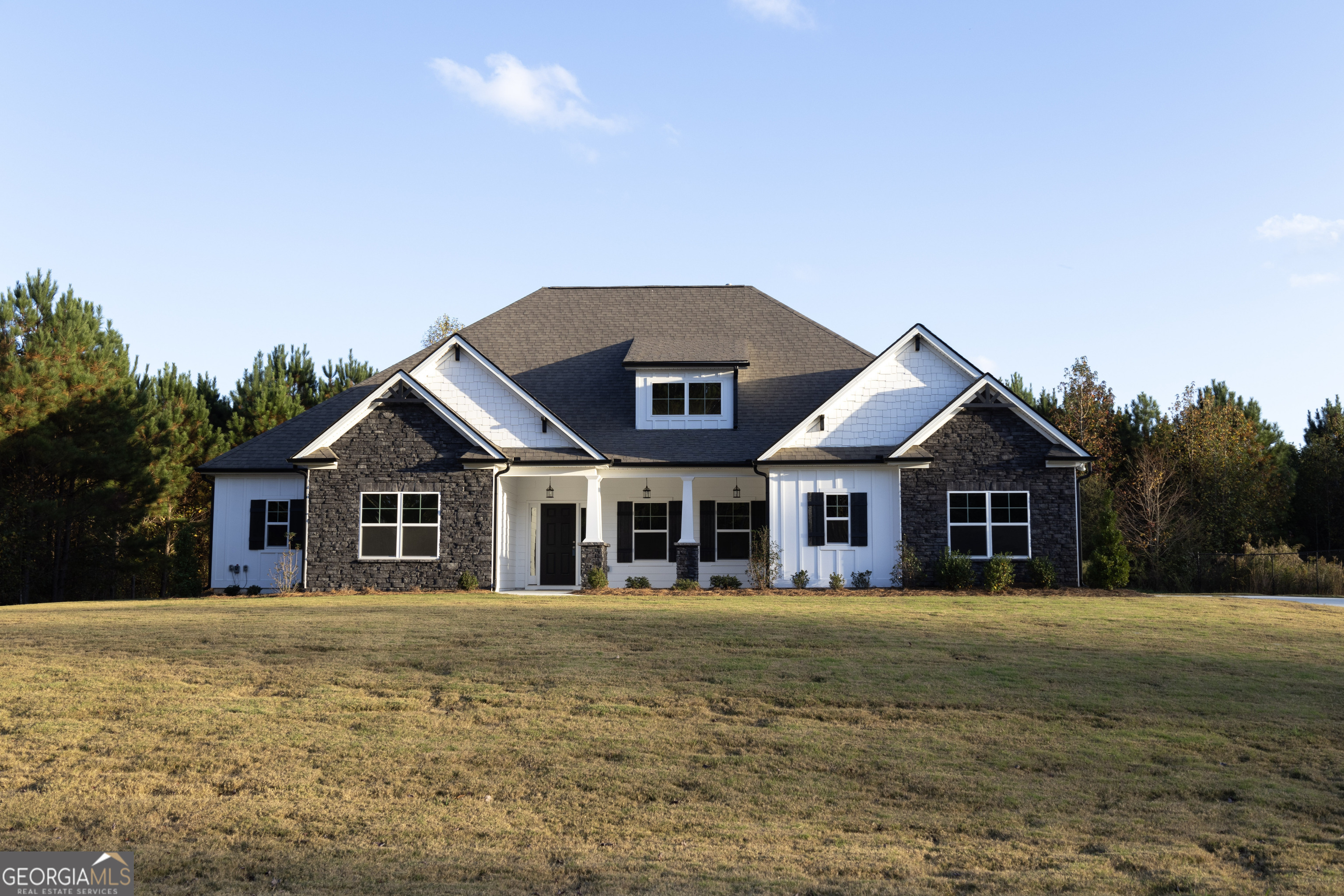 a front view of house with yard and green space