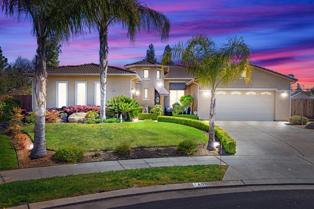 a front view of a house with a garden and yard