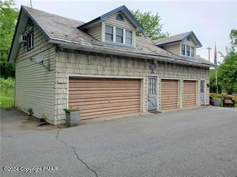 a view of a house with garage and yard