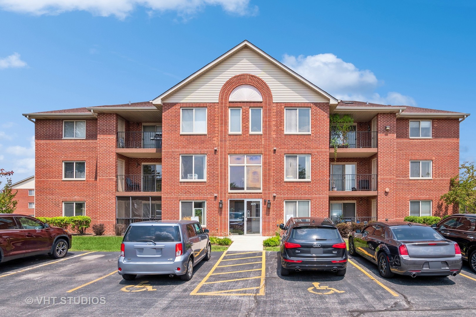 a front view of a residential apartment building with a yard