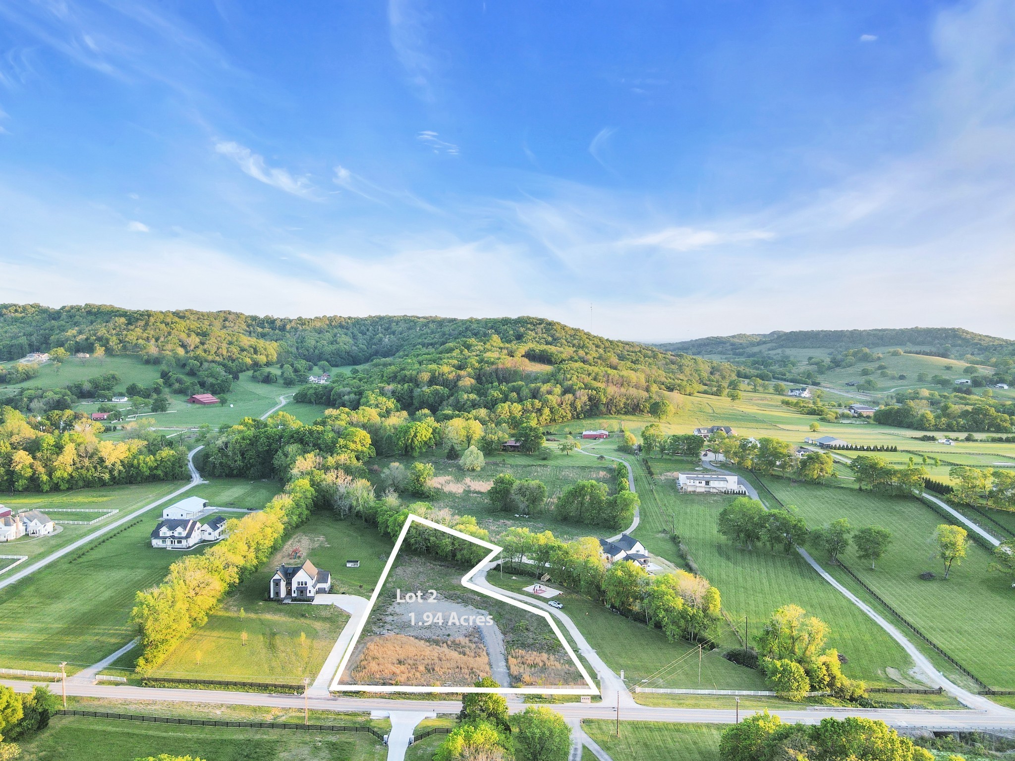 an aerial view of residential houses with outdoor space and river