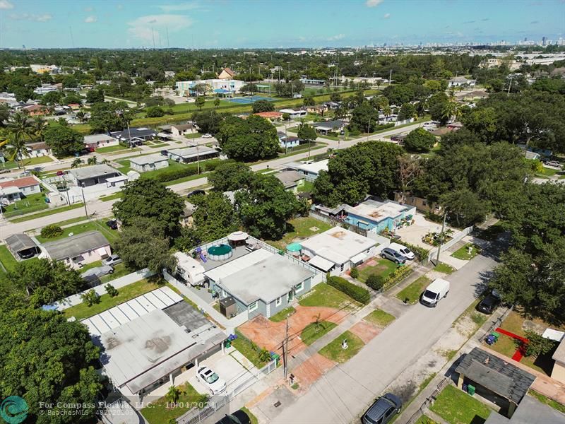 an aerial view of a residential houses with city view