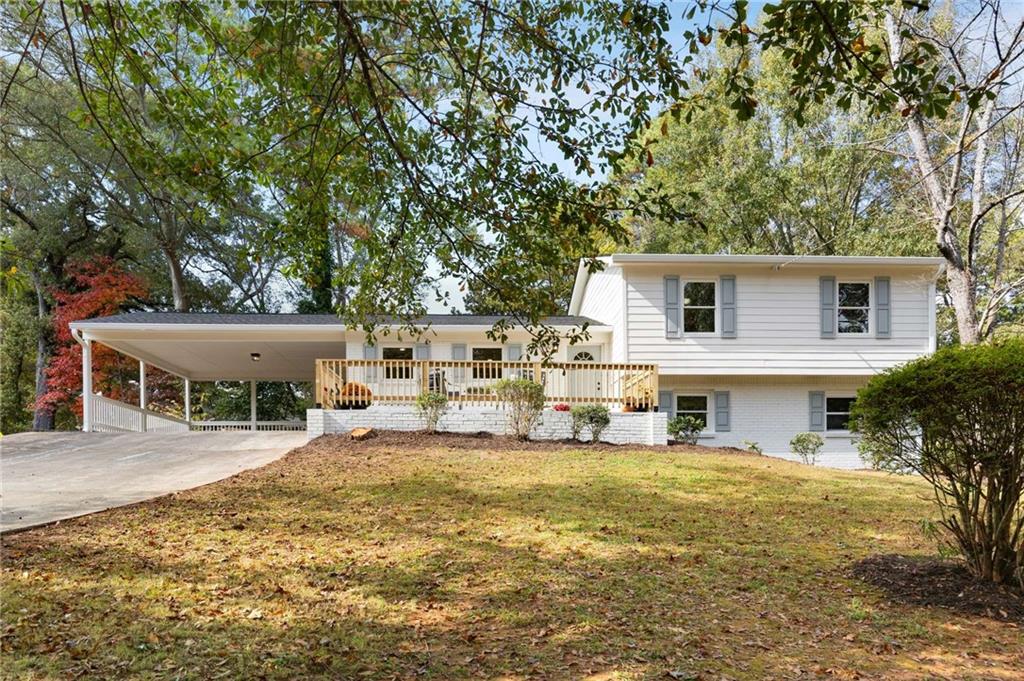 a view of a house with a yard patio and wooden fence