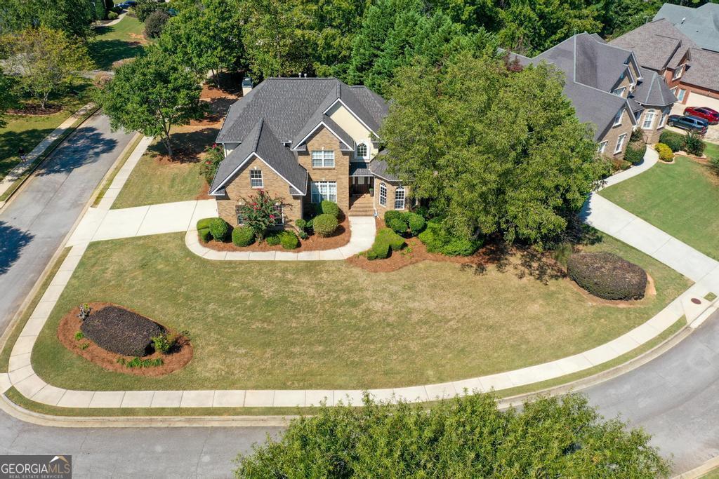 an aerial view of a house with swimming pool and red umbrella