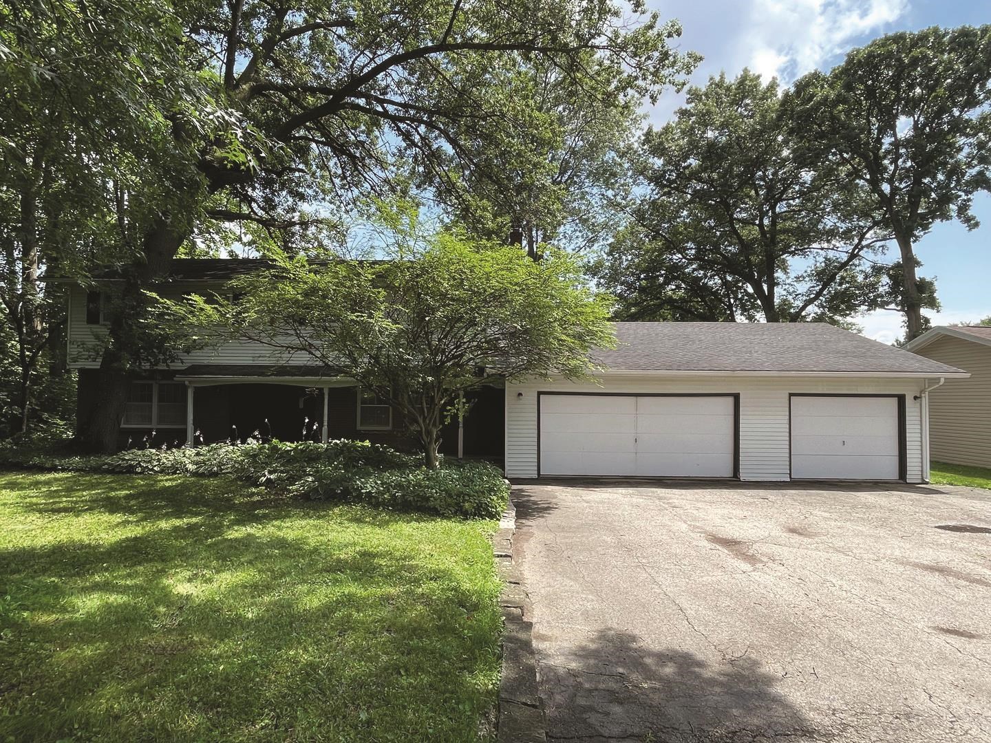 a front view of house with yard and trees