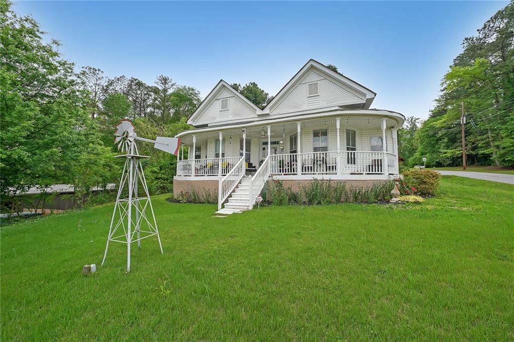 a front view of a house with a yard and trees