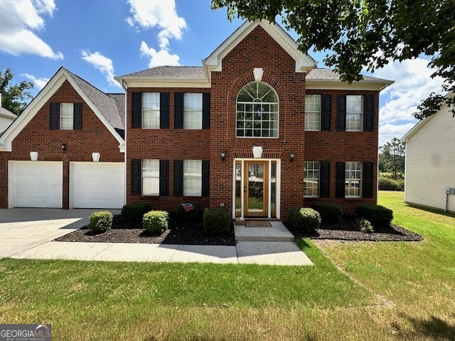 a front view of a house with a yard