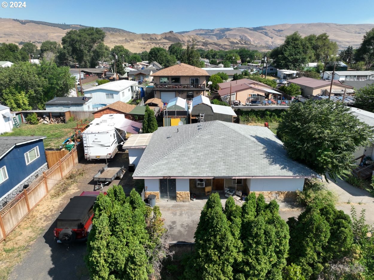 an aerial view of multiple houses with yard