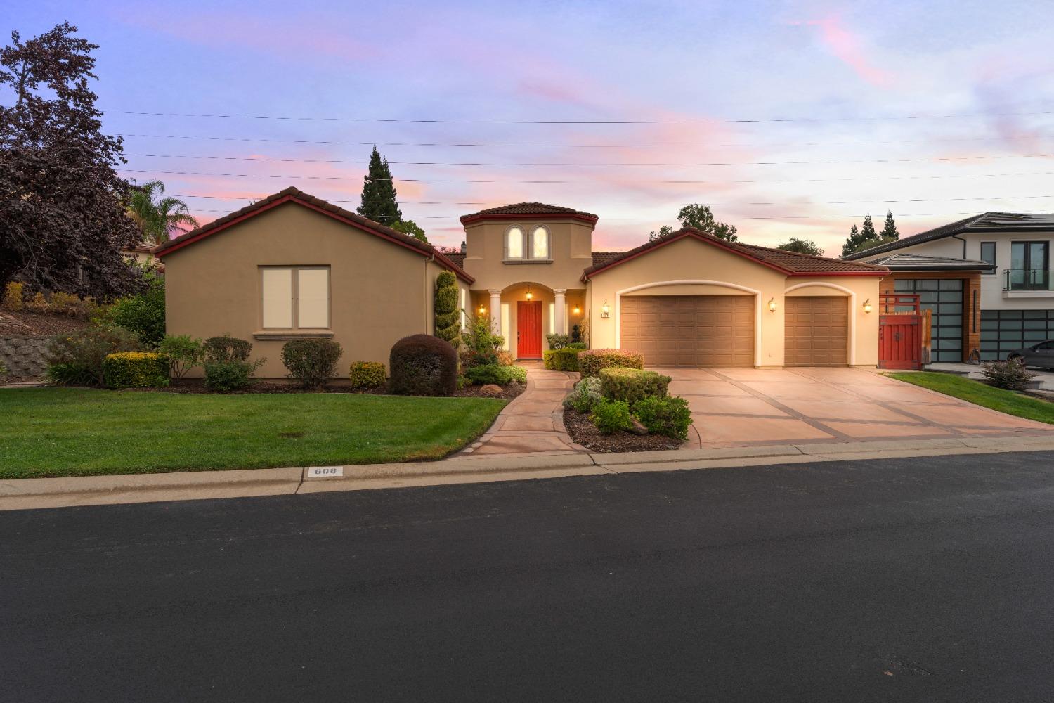 a front view of a house with a yard and garage